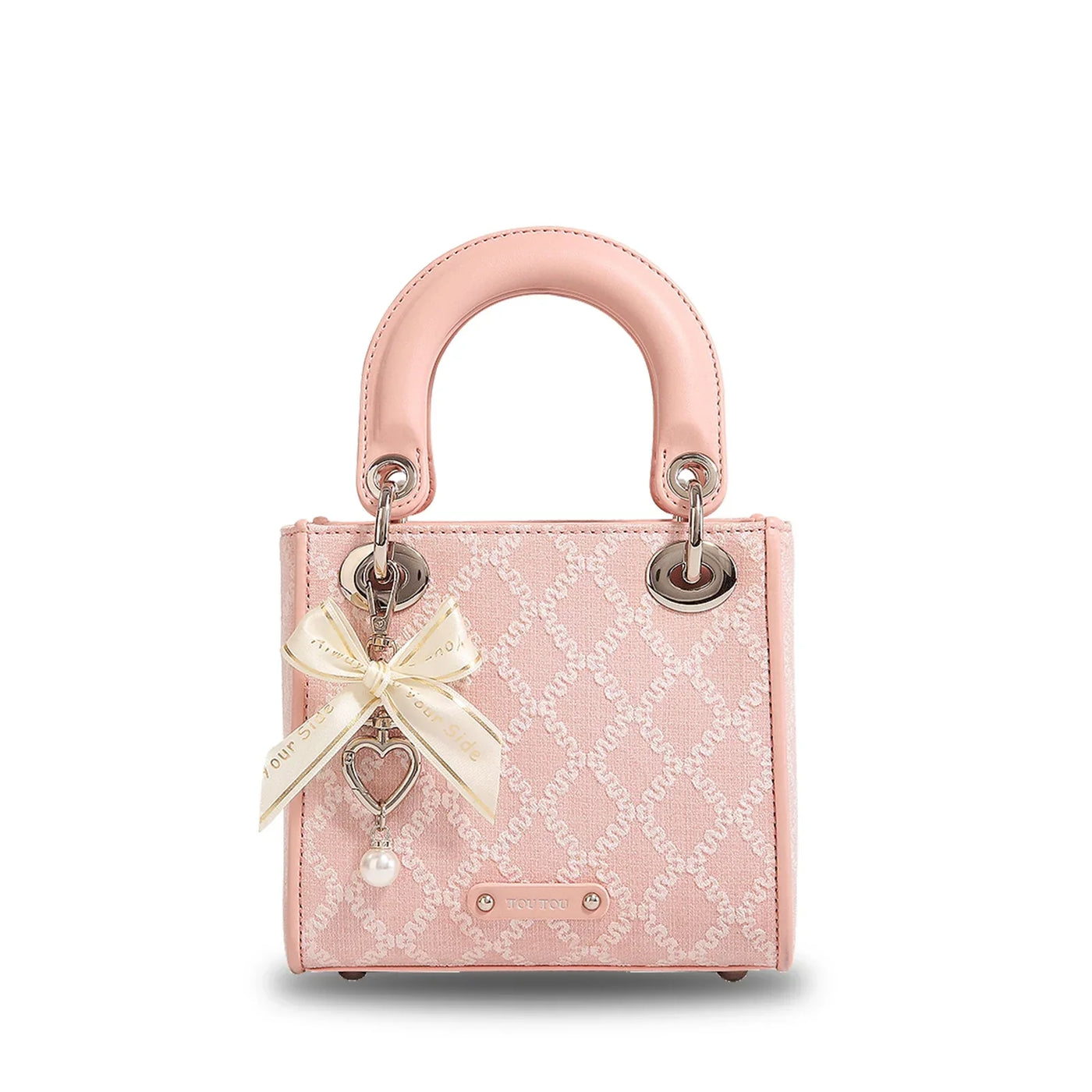 Clarisse Bow Jacquard Handbag in blush pink with pearl charm and bow accent, featuring elegant jacquard texture and structured top handles.